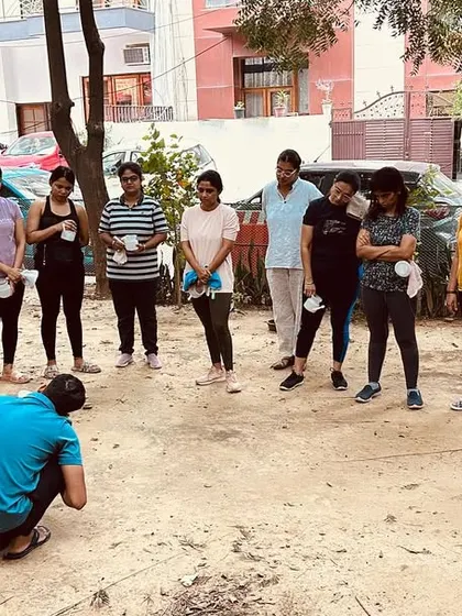 An instructor demonstrates the proper technique for Jal Neti to a group of students before they begin their own practice.