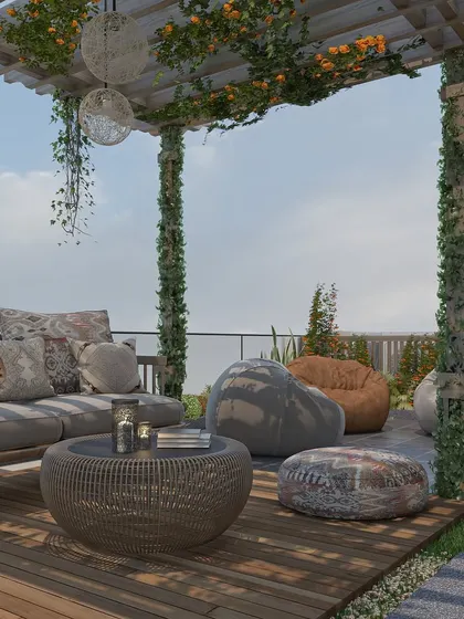 A relaxed outdoor seating arrangement with a sofa and bean bags on a wooden deck, perfect for casual gatherings.
