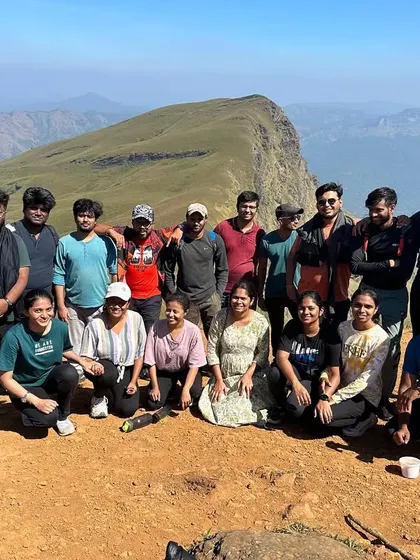 A New Year's batch enjoying a sunny day at the Nethravathi summit, with clear views of the surrounding peaks.