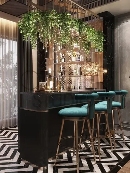 This bar area is a statement in itself, with a dramatic black and white chevron floor, a bar adorned with hanging greenery, and a quirky floor lamp, creating an experience with every cocktail.