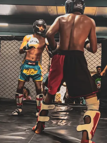 Two of our athletes exchanging strikes during an in-house kickboxing bout. These controlled fights are an excellent way for students to test their skills in a competitive setting.