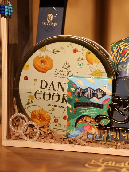 Another detail from the blue Diwali hamper, featuring a tin of Danish cookies, gourmet sweets, and pearl earrings.