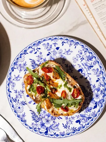 Crunchy, creamy, and perfection on a plate. Meet our Stracciatella Bruschetta, served on a beautiful blue and white floral plate.