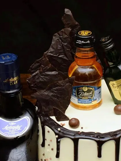 A detailed shot of the whiskey miniatures and chocolate sail. I love creating these arrangements to make each cake a unique centerpiece for your celebration.
