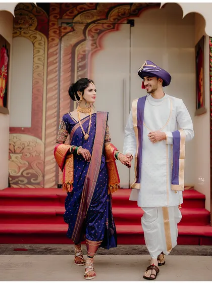 The grand exit. The couple walks hand-in-hand, stepping into their new life together, framed by the traditional doorway.