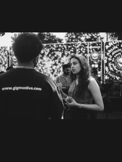A black and white shot of me talking to a team member from Gigman Live. Coordination and communication are key to a smooth show.