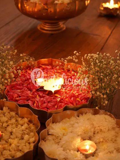 A closeup of a traditional urli filled with fresh rose petals and a floating candle. It’s these simple, beautiful details that bring warmth and a sense of serenity to festive home decor.