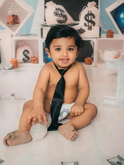 Holding his bottle like a true boss. This one-year-old had so much fun during his themed cake smash session.