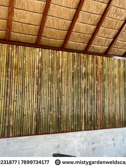 The interior of the cow shed features a wall made of natural bamboo poles, providing excellent airflow while maintaining a rustic and eco-friendly aesthetic.