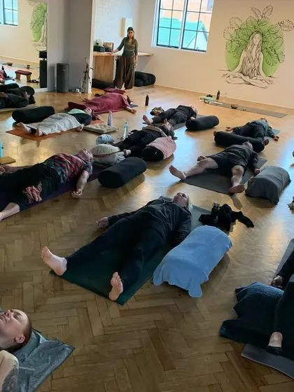 The end of a beautiful meditation and breathwork class, with everyone resting deeply in Savasana. This is where the body and mind absorb the full benefits of the practice.