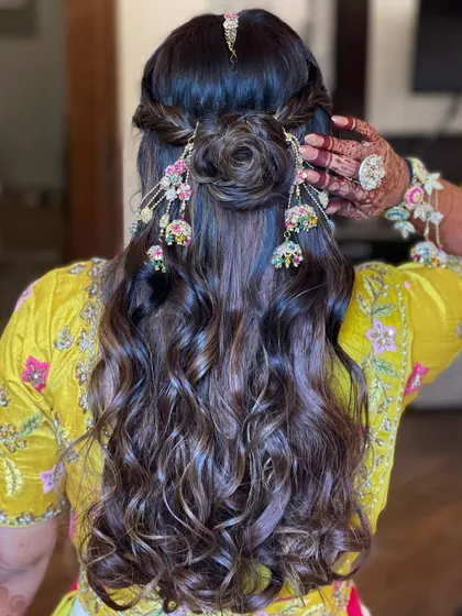 A detailed back view of the Haldi hairstyle, showing the hair rose and jhumki accessories.