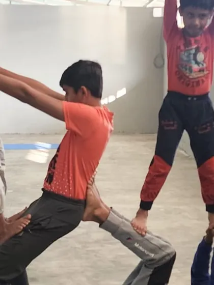 Teamwork in action. This multi-person pose requires every child to play their part, supporting each other to create a stable and impressive acrobatic structure.
