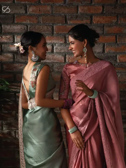 Discover designs that embody unapologetic elegance. Here, two of my clients share a moment in my pastel organza sarees, showcasing their individual styles.
