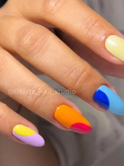 A closer look at our vibrant, multi-color abstract nail art. Each nail is a small piece of modern art, a technique that is very popular with clients who love a bold, creative style.