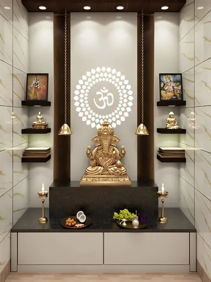 We designed this pooja space within a dedicated niche, using marble-finish tiles with golden veins to create a luxurious feel. The backlit OM panel serves as a divine focal point, complemented by hanging bells and floating shelves for a clean, modern, and Vastu-compliant layout.