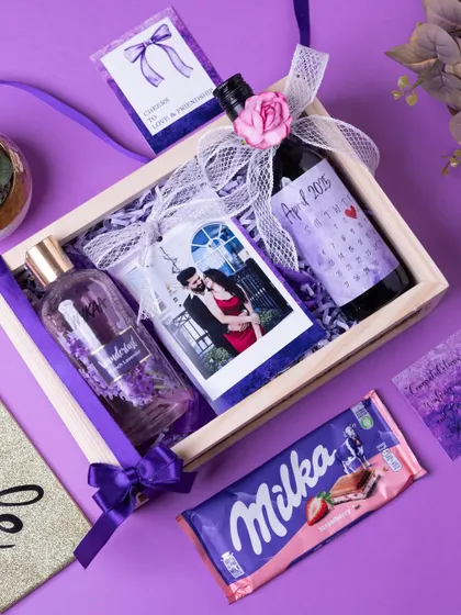 An overhead shot of the bride-to-be hamper, showing how the personalized photo, wine bottle, and other goodies are arranged.
