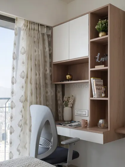 With the rise of remote work, a dedicated study table is essential. I integrated this compact workspace into the bedroom, providing storage for files and a niche to display cherished artifacts.
