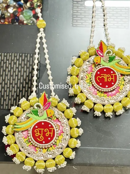 Welcome positivity into your home with these beautiful Shubh Labh hangings. The parrot motif and bright yellow beadwork make them a cheerful addition to your main door for Diwali and beyond.