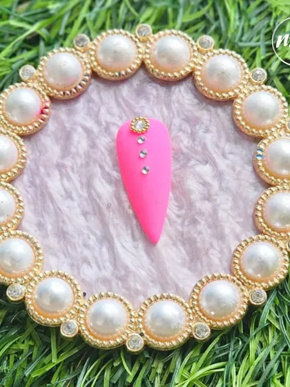 A simple yet striking design by a student. The hot pink matte nail with a single line of rhinestones is a great example of minimalist glam.