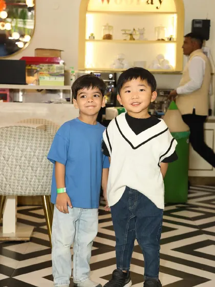 Two young friends pose for a photo in our stylish cafe area.