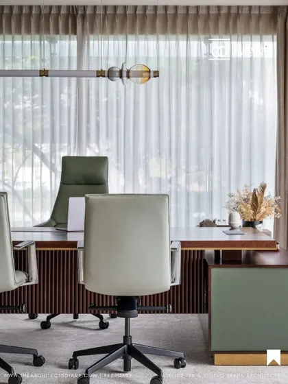 Natural light and a connection to the outdoors were key in this executive office design. We used sheer curtains to soften the light and chose mint green leather chairs to add a subtle touch of color.