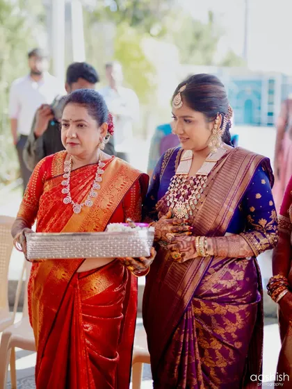 A candid moment between the bride and her mother during a ceremony. It was a pleasure creating harmonious looks for them both.