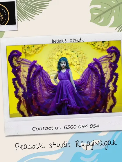 A stunning photo of a young girl in a dramatic purple gown with butterfly-wing-like trails, posing in our studio.