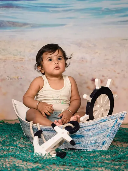 Explore our full nautical and beach-themed collection. These images showcase the variety of poses and angles possible with our boat prop, sand-colored flooring, and ocean backdrop.