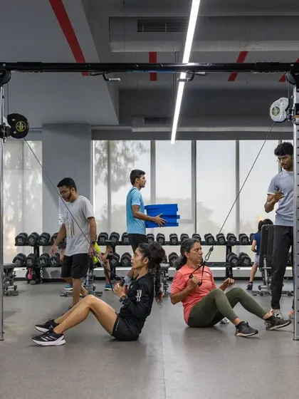 Members engage in seated cable rows, another key exercise in our program for strengthening the back and improving core stability for better running mechanics.