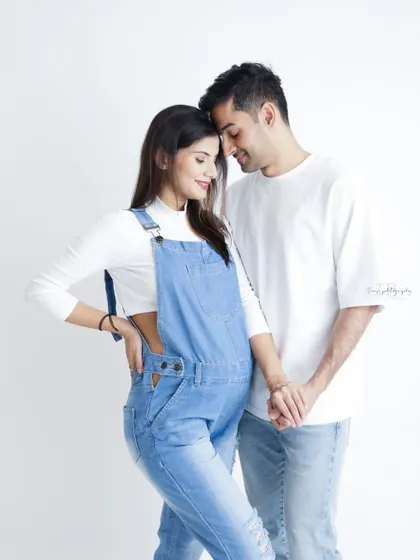 A relaxed and intimate couple's portrait in casual denim. Their loving hold and gentle smiles create a beautiful and authentic moment.