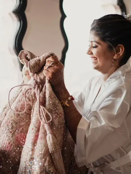 The bride's excitement as she unveils her wedding lehenga. We coordinate every detail, including the special moments of getting ready.