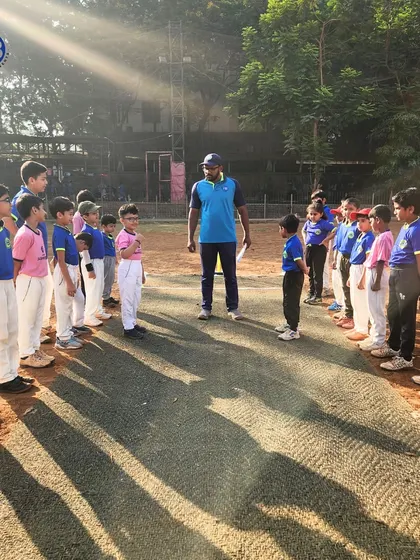 Rising stars in action. A coach addresses his team on the pitch, instilling dedication and a spirit of teamwork before a game.
