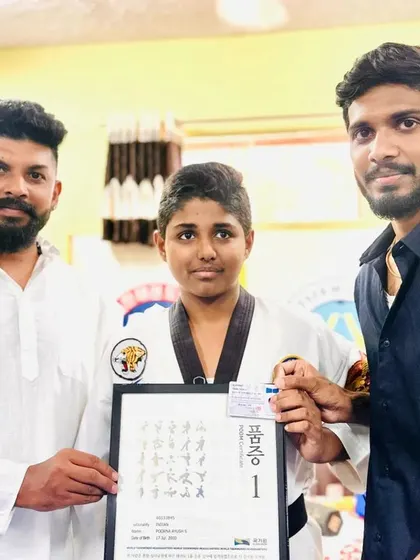 Presenting a black belt certificate to a proud student.