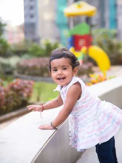 A playful, candid shot of a little girl enjoying her time at the park during our family session.