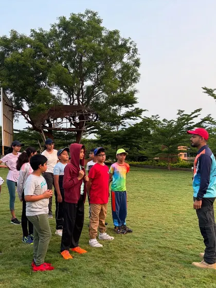 An instructor briefs a group of attentive young campers before an activity. Clear communication and instruction are key to a safe and successful outdoor experience.