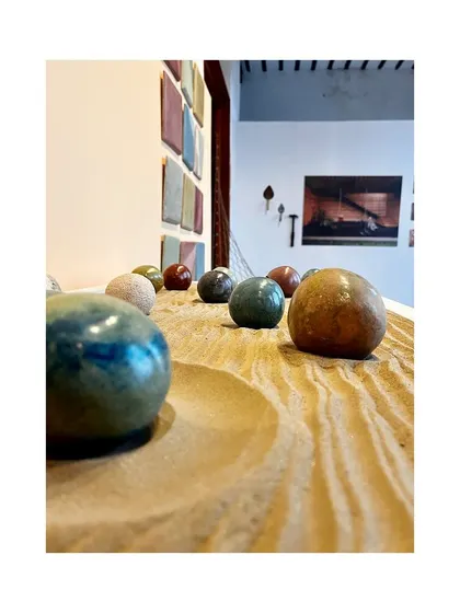 The polished, stone-like finish of the Tadelakt spheres, resting in a bed of sand, created a beautiful and engaging display.