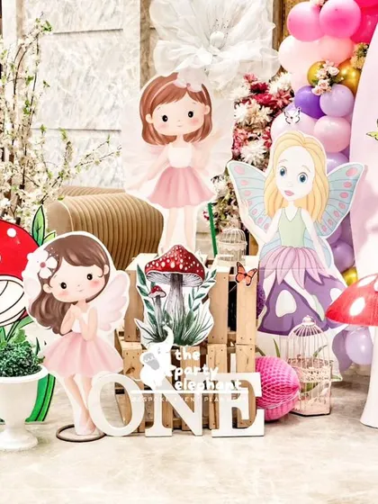 A delightful collection of fairy and mushroom cutouts creating a whimsical scene at the entrance of the party.