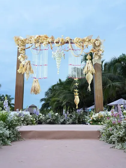 The entrance arch to the beachfront wedding ceremony in Vietnam, decorated with local handcrafted elements and fresh flowers. It set a welcoming and culturally rich tone for the event.