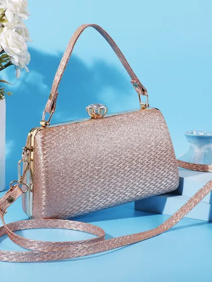 A fresh and modern shot of the rose gold clutch against a cool blue background. The clean lines and simple props give it a contemporary and stylish feel.