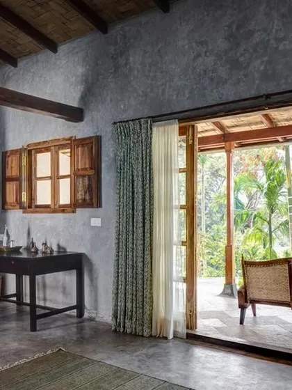 The interior of the Green Room, showing how the bedroom flows onto a private veranda with expansive views.
