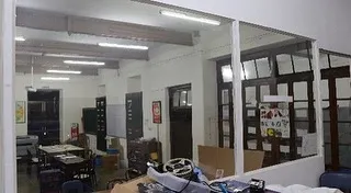 Another 'before' shot, showing the makeshift divisions that had been installed over the years, obscuring the building's grand proportions.