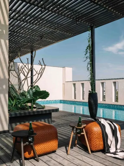 The rooftop terrace of Project 1374 is designed as a seamless extension of the home. A wooden deck, shaded pergola, and private pool create a tranquil entertainment zone where the interplay of raw, tactile surfaces and curated greenery continues to unfold.