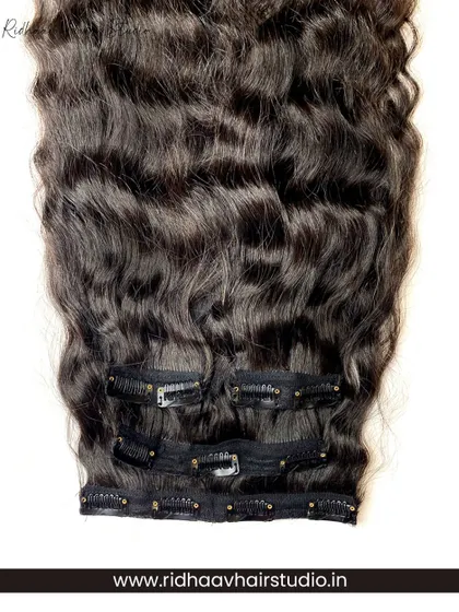 A close-up of the clips on our curly hair extension set. The clips are designed to grip securely onto your natural hair, ensuring your voluminous curls stay put all day.