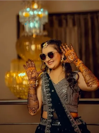 Another shot of the bride with sunglasses, showing her fun personality and beautiful mehndi.