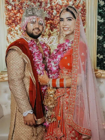 A classic portrait of the couple at their wedding reception. They look happy and radiant, posing together in their beautiful wedding attire.