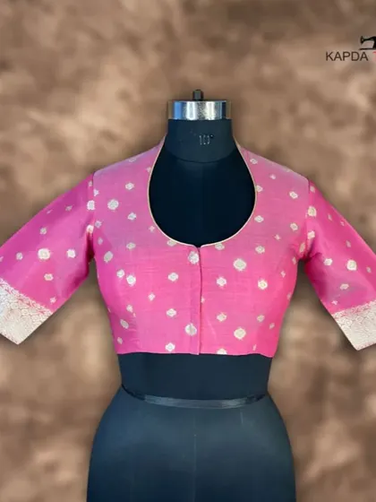 A front view of the Banarasi pink brocade blouse. The U-neck and front button closure offer a clean, sophisticated look, while the rich fabric makes it perfect for special occasions.