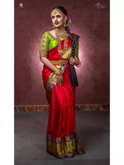 The full view of the red and green bridal saree, showing the elegant drape and the richness of the complete outfit available for rent.