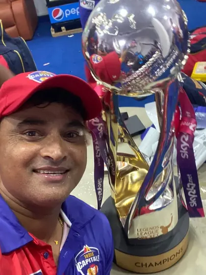 A close-up selfie with the championship trophy in the dressing room, capturing the immediate post-victory celebration.