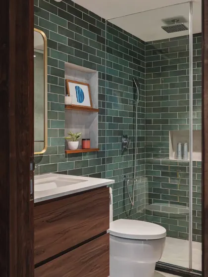 A third variation on the same bathroom layout, this time with a deep green subway tile. This color creates a rich, earthy, and calming atmosphere, turning the shower area into a beautiful feature.