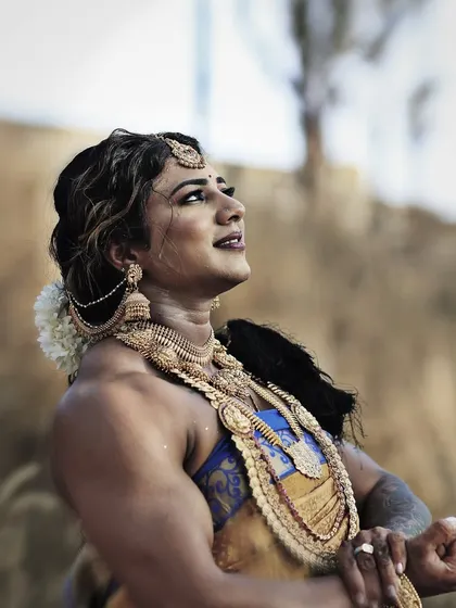 Looking up towards my goals, adorned in the richness of my culture. My strength is deeply rooted in my identity.